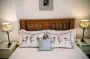 Double bed with quality sheep themed linen and bedside lamps
