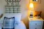 Cosy single bed with dressing table and lamp