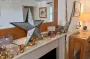 A mantle piece attractively decorated with lights and mirror